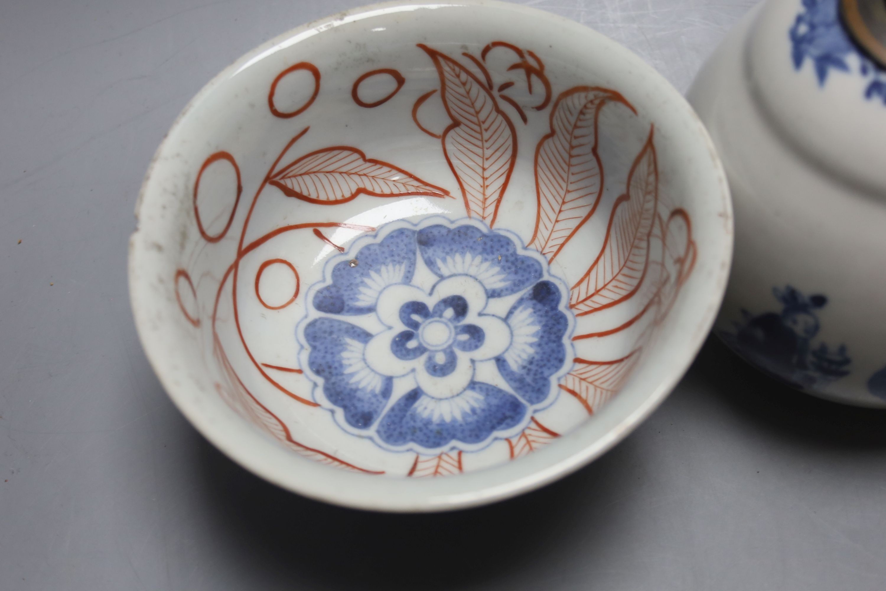 A Chinese blue and white water pipe vessel, a doucai stem dish and a Japanese Imari bowl, 19th century, (3)